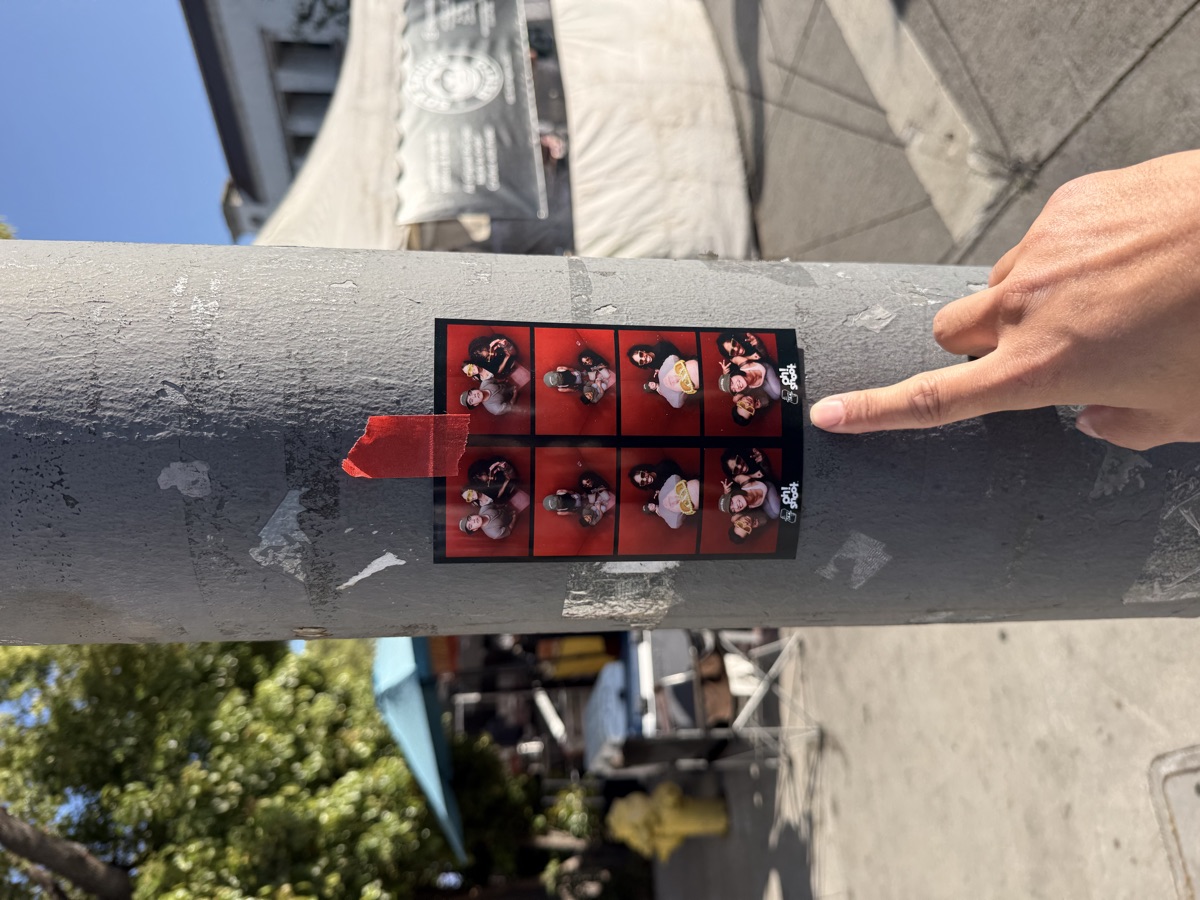 Finger pointing at a strip on a street pole